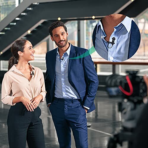 Two professionals being recorded with a focus on a lapel microphone.